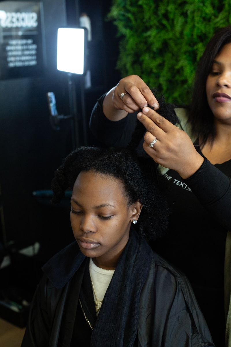 Student working on a client at ALA Beauty Academy